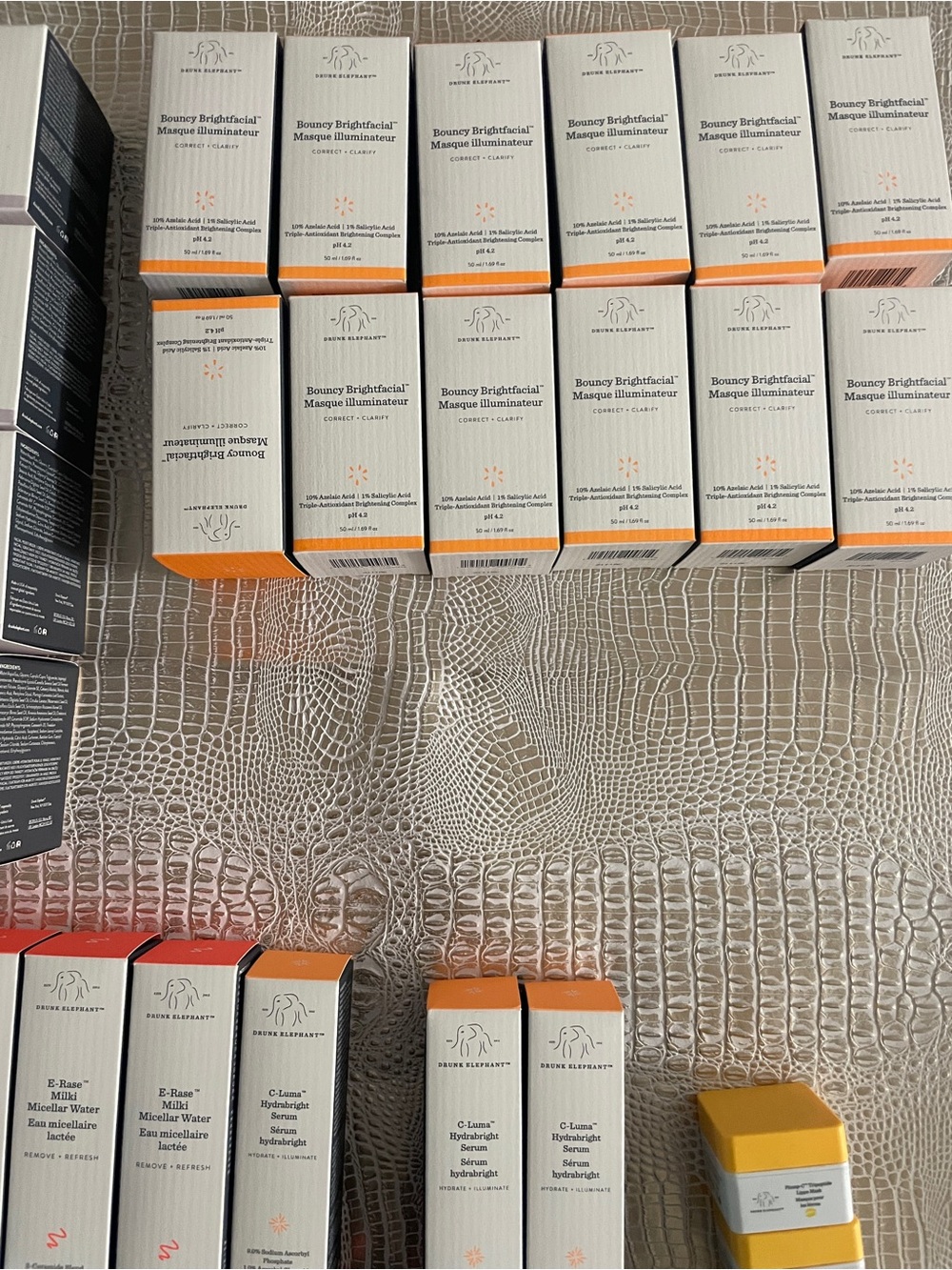 Drunk Elephant skincare boxes with orange accents
